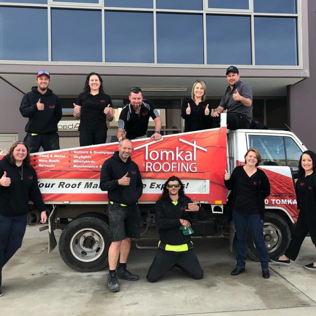 Trusted roofing professional inspecting roof shingles for repair and replacement