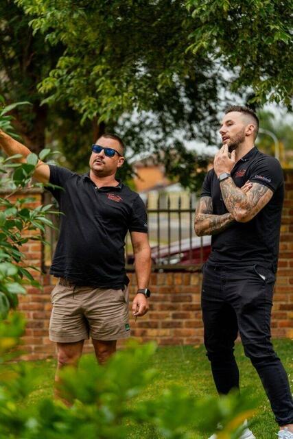 Tomkat Roofing team discussing roof repair Sydney project during on-site inspection.