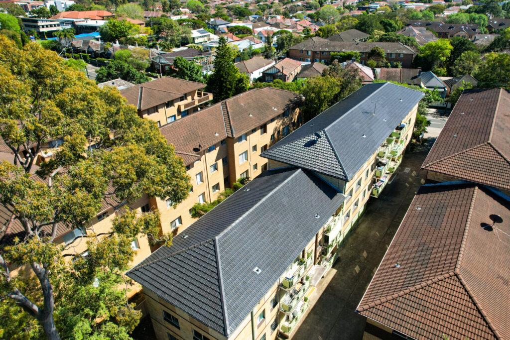 Aerial view of storm damaged roof with emergency tarping in Sydney