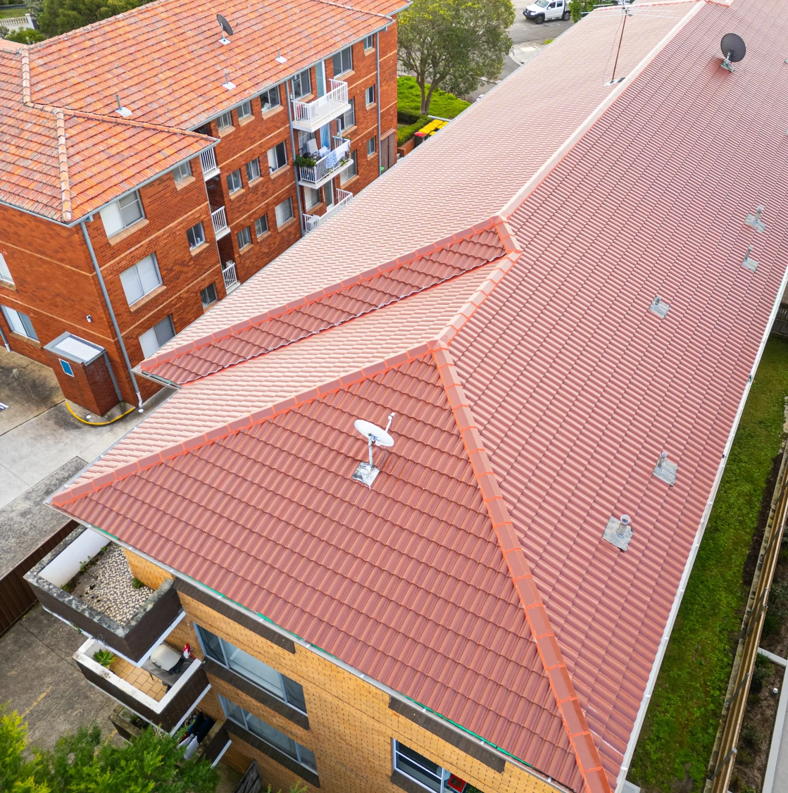 How Do Roof Tiles Keep Water Out on a multi-storey building with overlapping tiles