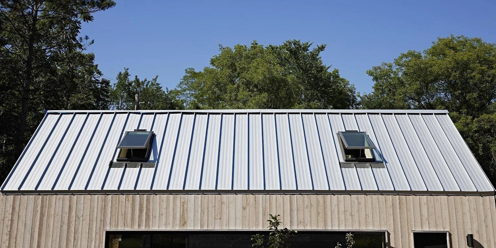 Corrugated metal roof with installed skylights maximising natural light in Sydney home.