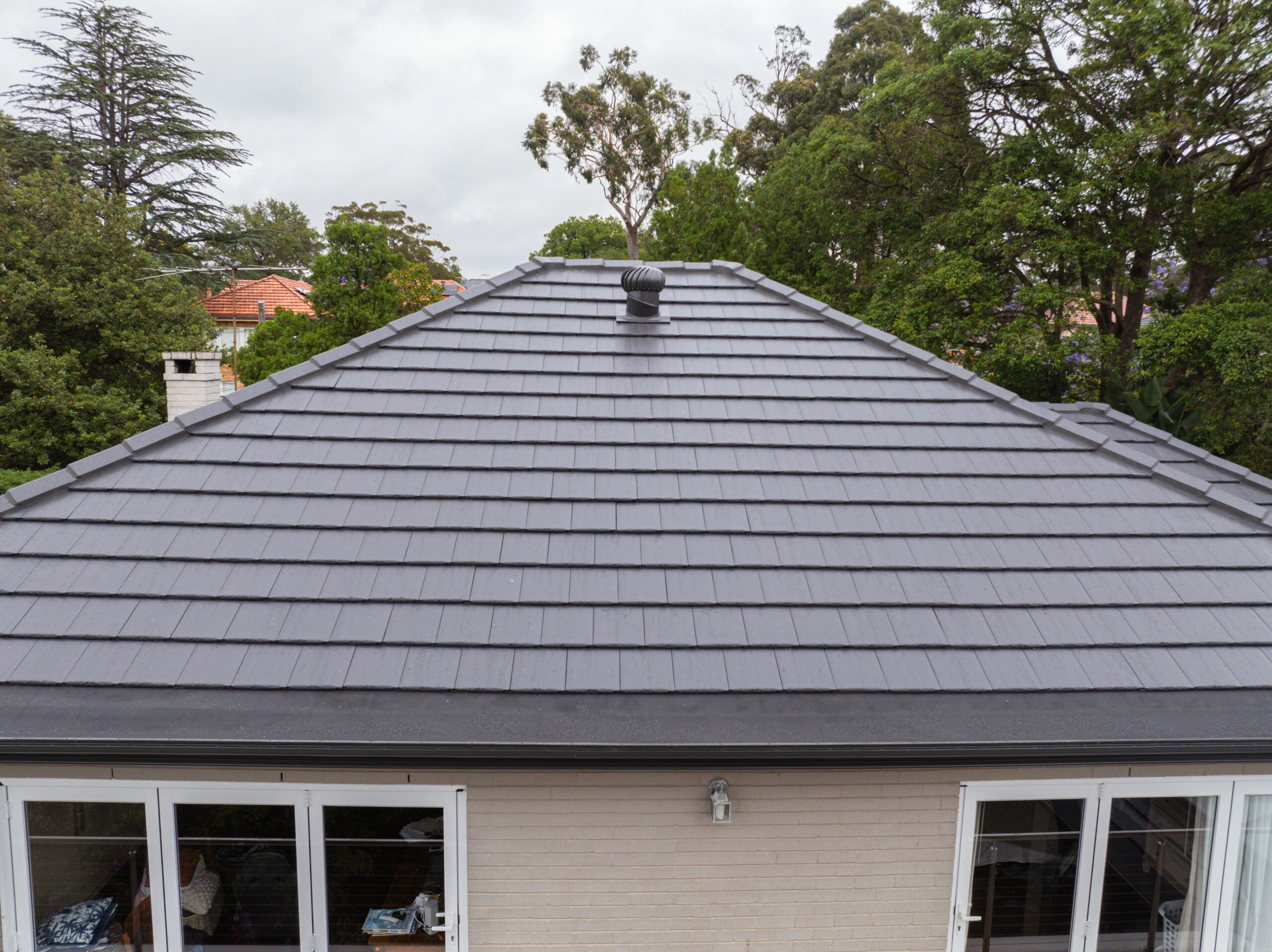 Professional roof cleaning service preparing tiles for restoration treatment