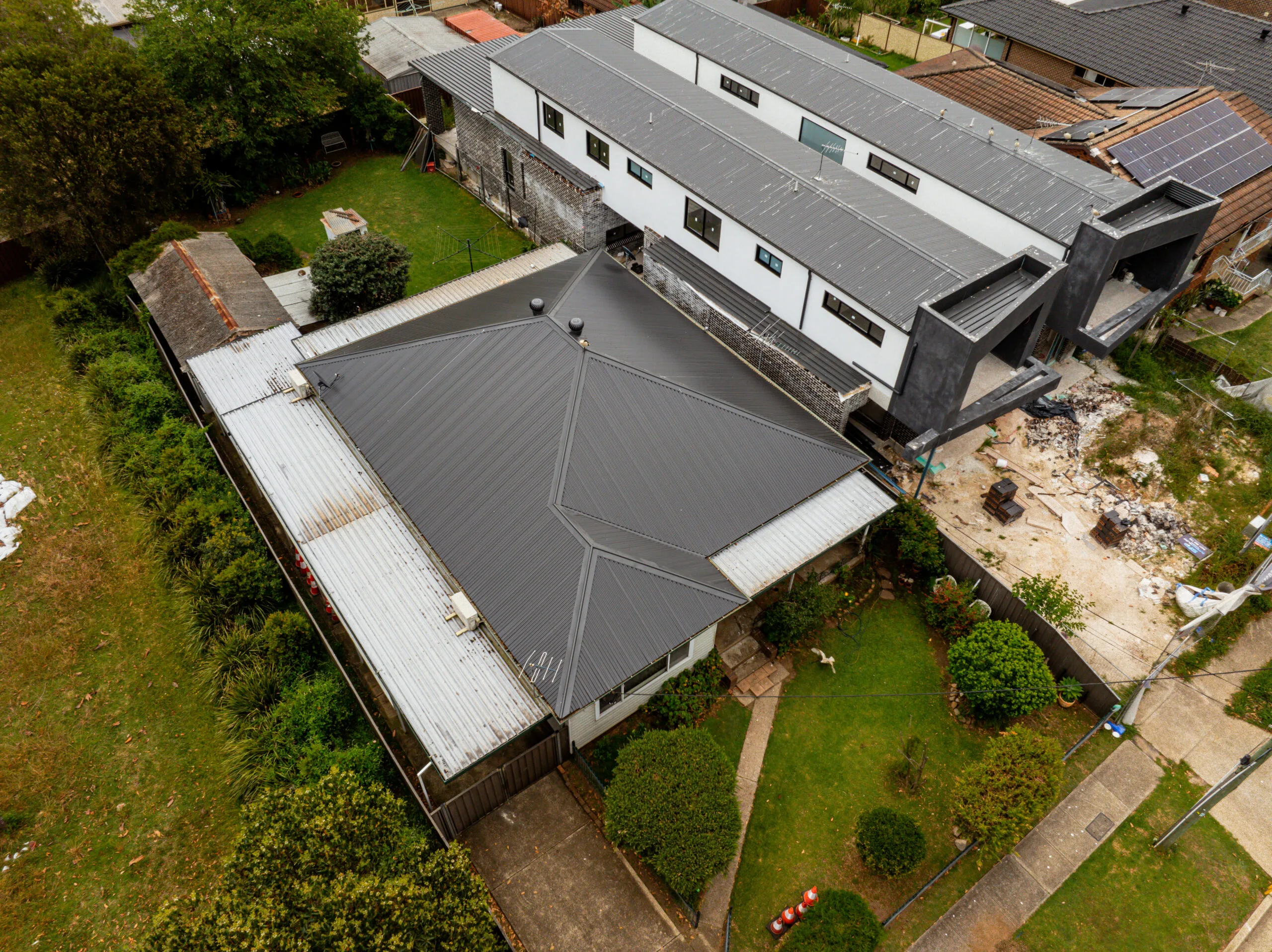 Modern metal roof installation on Sydney home after tile roof conversion with surrounding residential area