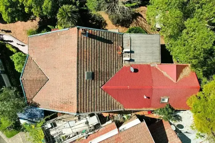 Residential roofing project showing clean tile alignment and roof vent feature