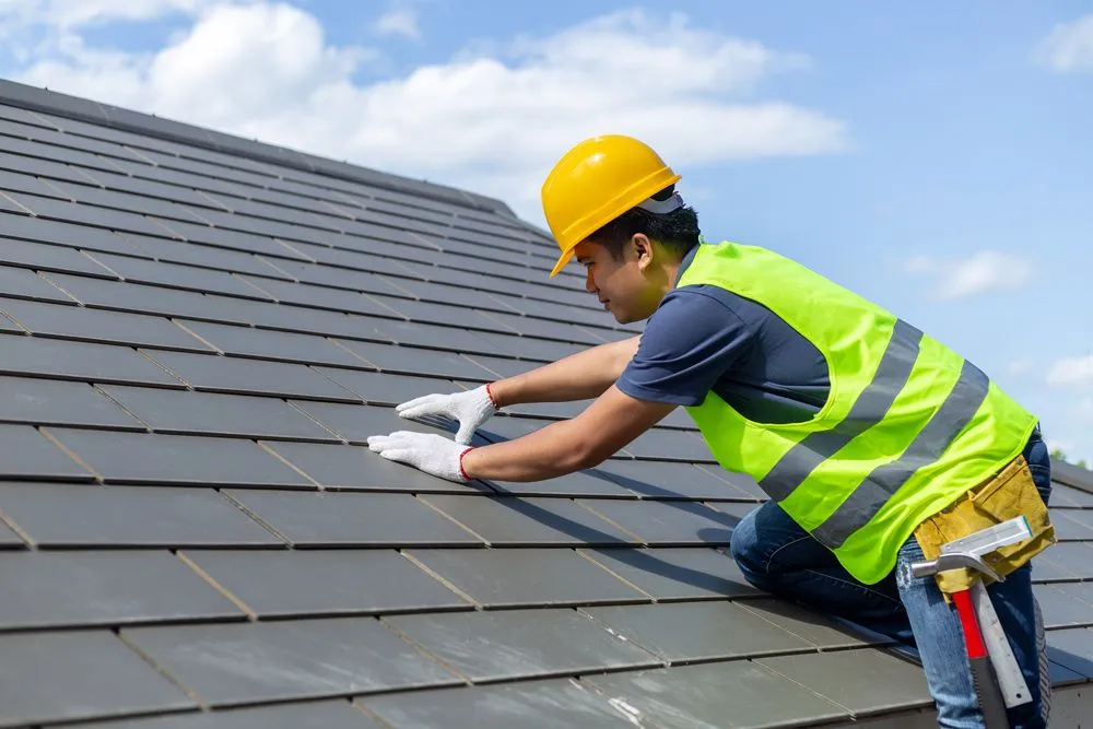 Tomkat Roofing inspector preparing a detailed photo report for an insurance claim after a Sydney storm.