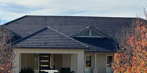 Solar panels temporarily lifted off a Sydney home roof during repair by Tomkat Roofing